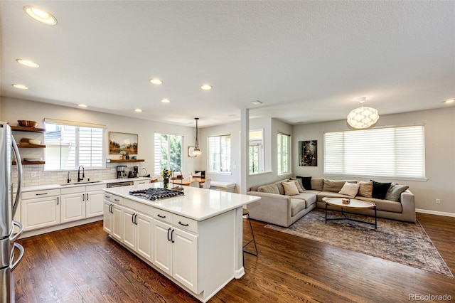 4970 Laurelglen Ln, Highlands Ranch, CO 80130 - kitchen featuring open shelves, a sink, a kitchen island, appliances with stainless steel finishes, and white cabinets