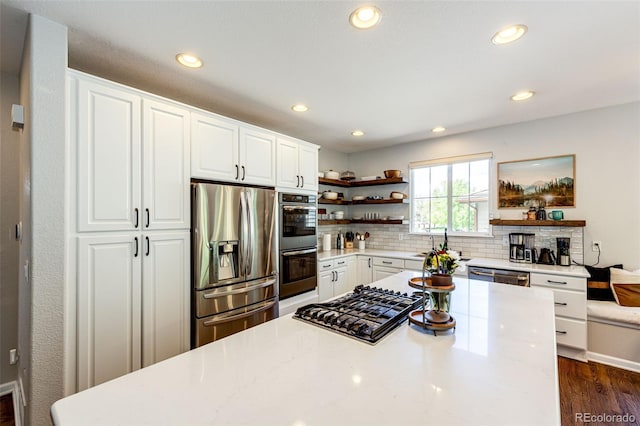 4970 Laurelglen Ln, Highlands Ranch, CO 80130 - kitchen with stainless steel appliances, open shelves, recessed lighting, dark wood-style flooring, and decorative backsplash