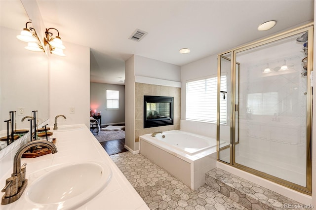 4970 Laurelglen Ln, Highlands Ranch, CO 80130 - full bath with a jetted tub, a shower stall, a tile fireplace, double vanity, and tile patterned floors