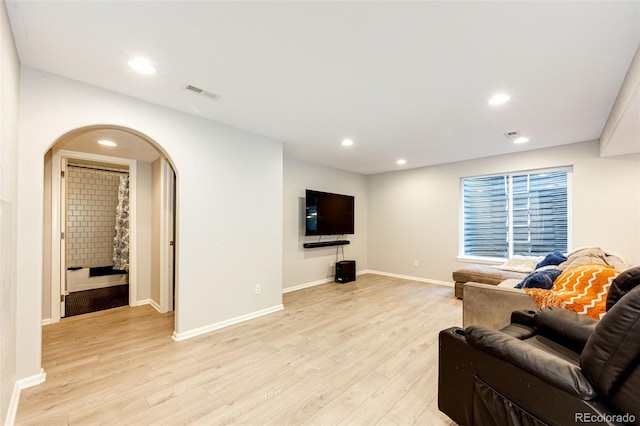 4970 Laurelglen Ln, Highlands Ranch, CO 80130 - living room with arched walkways, light wood-style floors, recessed lighting, and baseboards