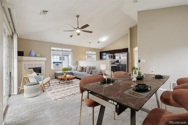 3262 E 103rd Dr Unit 1806, Thornton, CO 80229 - living room with ceiling fan, a tiled fireplace, carpet, and high vaulted ceiling