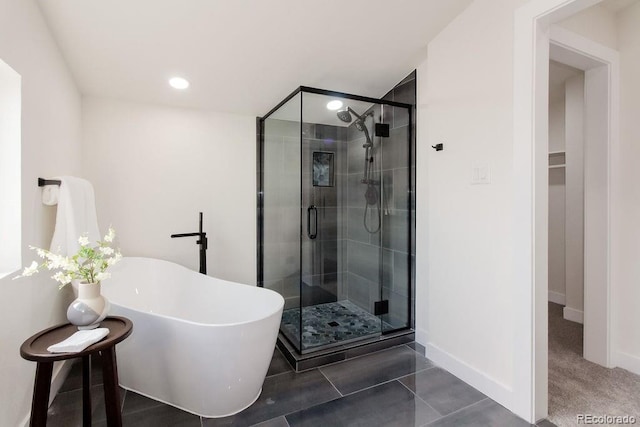 full bath with a stall shower, baseboards, a freestanding bath, and recessed lighting