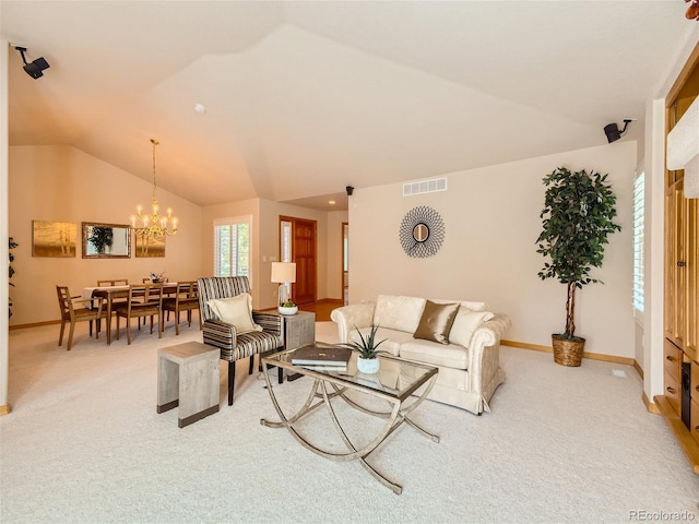 living room with carpet, a notable chandelier, and vaulted ceiling