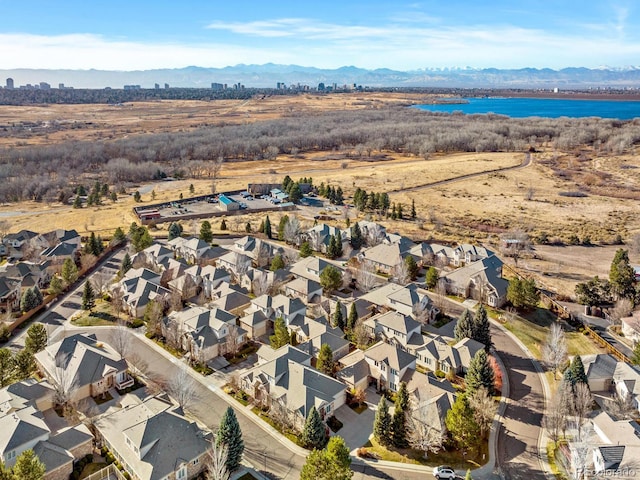 birds eye view of property featuring a water and mountain view