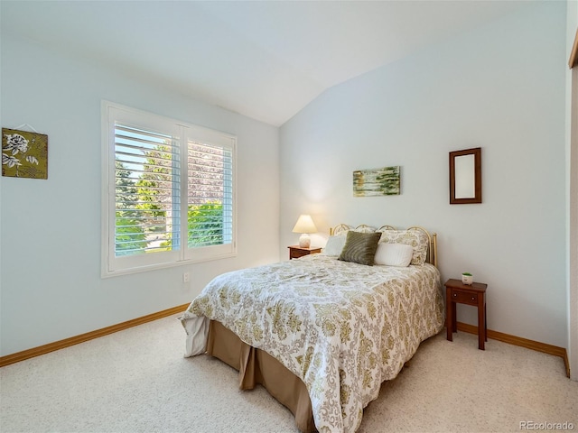 carpeted bedroom with vaulted ceiling