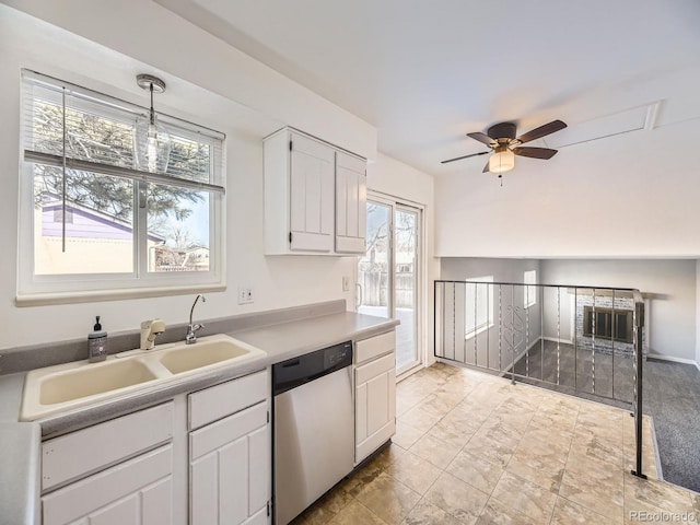 kitchen featuring decorative light fixtures, sink, white cabinets, stainless steel dishwasher, and ceiling fan