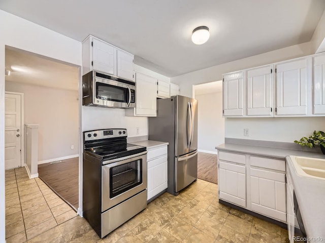 kitchen featuring white cabinetry and appliances with stainless steel finishes