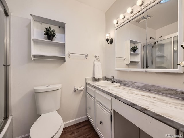 bathroom featuring vanity, toilet, and hardwood / wood-style floors