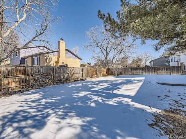 view of yard layered in snow