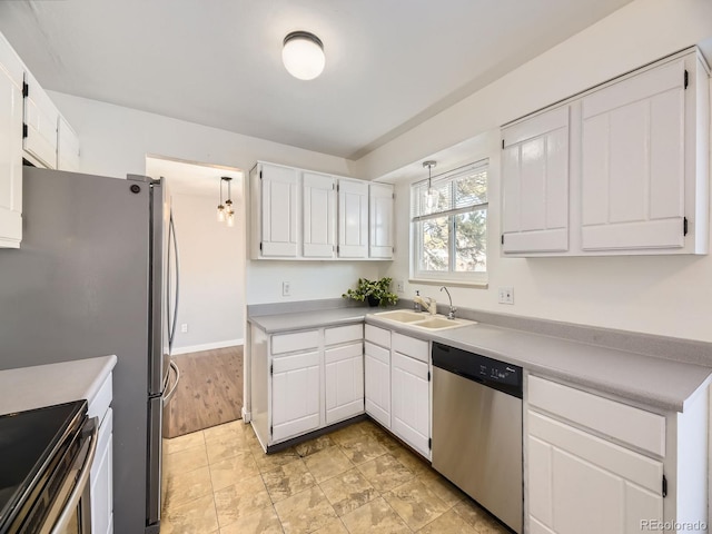 kitchen with sink, stainless steel appliances, and white cabinets