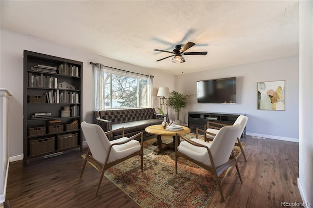 living room with ceiling fan, a textured ceiling, and dark hardwood / wood-style flooring