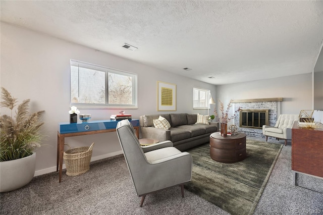 living room with a fireplace, a textured ceiling, and carpet flooring