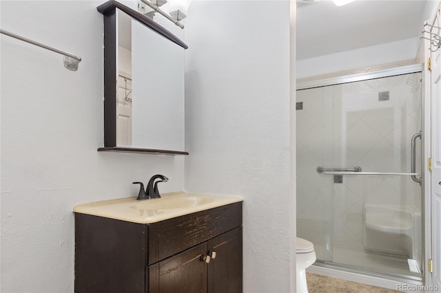 full bath with toilet, a shower stall, and vanity
