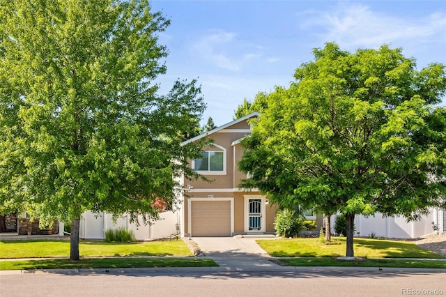 18672 E Chaffee Pl, Denver, CO 80249 - view of property hidden behind natural elements featuring concrete driveway, stucco siding, a garage, and a front yard