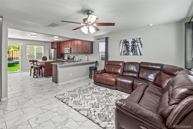 18672 E Chaffee Pl, Denver, CO 80249 - living area with light marble finish flooring and ceiling fan