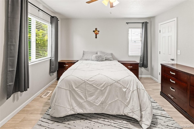 18672 E Chaffee Pl, Denver, CO 80249 - bedroom featuring light wood-style floors, multiple windows, and a ceiling fan