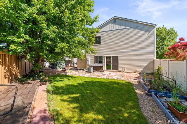 18672 E Chaffee Pl, Denver, CO 80249 - back of property with a garden, a fenced backyard, a hot tub, and a patio