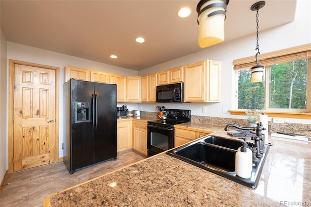 kitchen featuring hanging light fixtures, a sink, black appliances, light brown cabinets, and recessed lighting