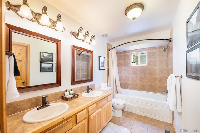 full bathroom featuring tile patterned flooring, a sink, shower / tub combo with curtain, and toilet