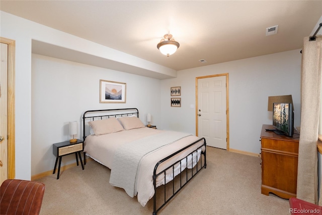 bedroom with visible vents, baseboards, and light colored carpet