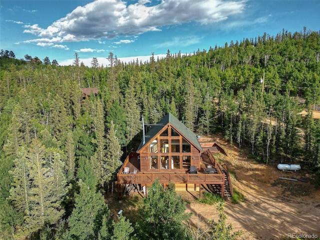 birds eye view of property featuring a wooded view