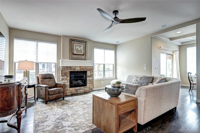 15160 W Iliff Pl, Lakewood, CO 80228 - living room featuring plenty of natural light, ceiling fan, dark wood-type flooring, and a fireplace