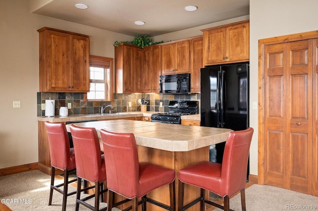 45 County Road 5223 Unit 25B, Tabernash, CO 80478 - kitchen featuring black appliances, a center island, backsplash, tile countertops, and a breakfast bar