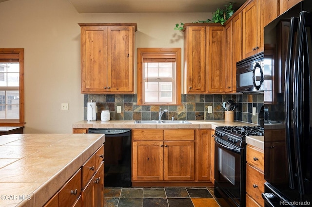 45 County Road 5223 Unit 25B, Tabernash, CO 80478 - kitchen featuring black appliances, tile counters, decorative backsplash, brown cabinetry, and dark stone finish floors