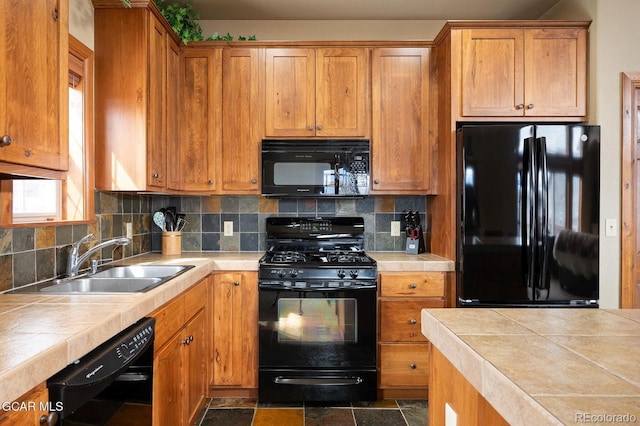45 County Road 5223 Unit 25B, Tabernash, CO 80478 - kitchen with black appliances, tile counters, backsplash, and brown cabinetry