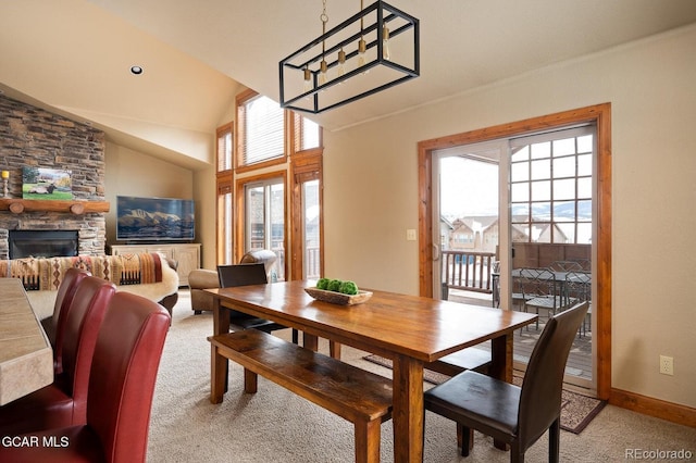45 County Road 5223 Unit 25B, Tabernash, CO 80478 - dining space featuring light colored carpet, a fireplace, lofted ceiling, and a chandelier