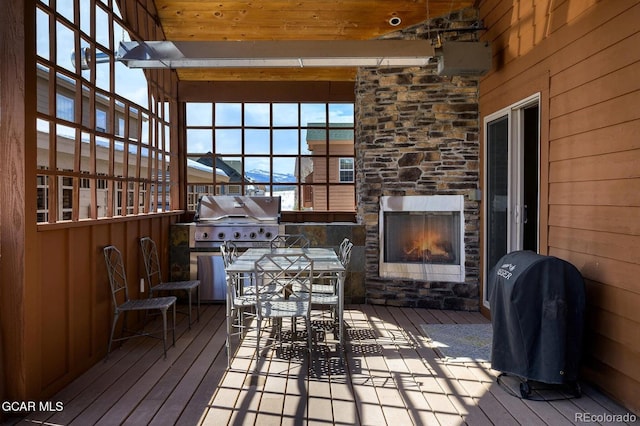 45 County Road 5223 Unit 25B, Tabernash, CO 80478 - wooden terrace featuring an outdoor stone fireplace, area for grilling, and outdoor dining space