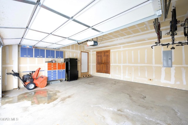 45 County Road 5223 Unit 25B, Tabernash, CO 80478 - garage with freestanding refrigerator, electric panel, and a garage door opener
