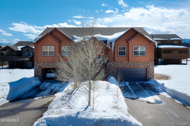 45 County Road 5223 Unit 25B, Tabernash, CO 80478 - view of front of property featuring stone siding, a garage, and driveway