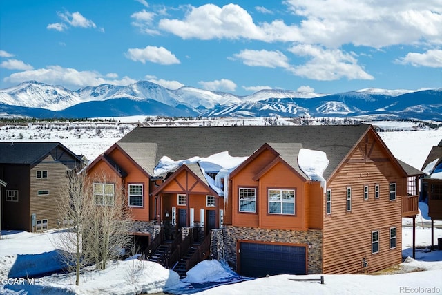 45 County Road 5223 Unit 25B, Tabernash, CO 80478 - chalet / cabin featuring stone siding, a mountain view, and a garage