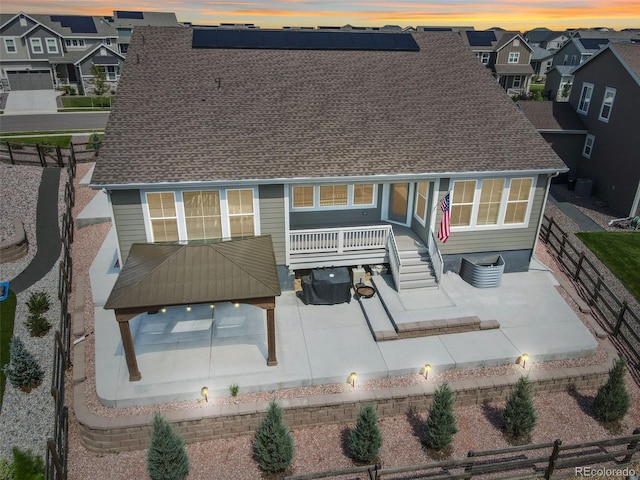 5128 Preserve Pl, Firestone, CO 80504 - rear view of house featuring a patio area, a fenced backyard, and solar panels