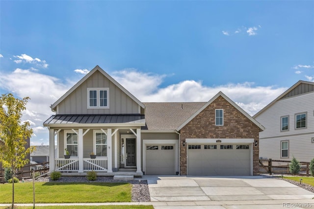 5128 Preserve Pl, Firestone, CO 80504 - view of front facade with an attached garage, board and batten siding, driveway, covered porch, and a shingled roof