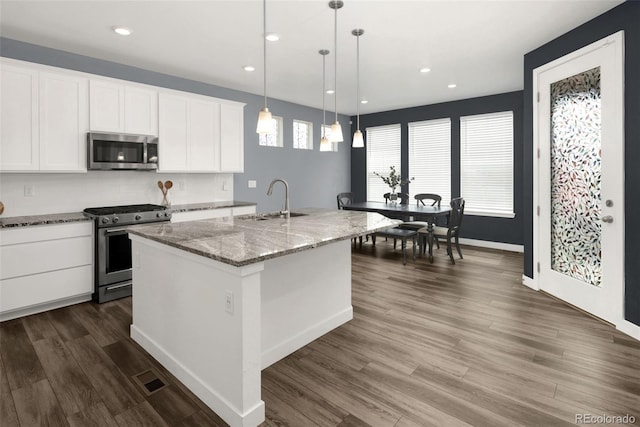 5128 Preserve Pl, Firestone, CO 80504 - kitchen featuring stainless steel appliances, white cabinetry, dark wood-style flooring, light stone countertops, and recessed lighting