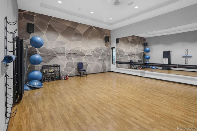 5128 Preserve Pl, Firestone, CO 80504 - exercise area with wood finished floors, recessed lighting, a tray ceiling, and a fireplace