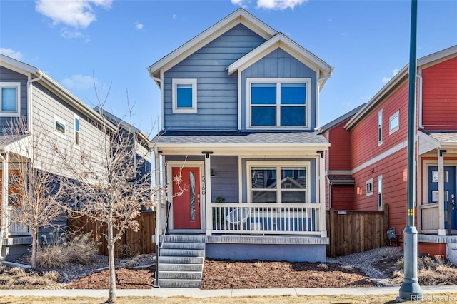 5760 N Boston St, Denver, CO 80238 - view of front of home with a porch, fence, and board and batten siding