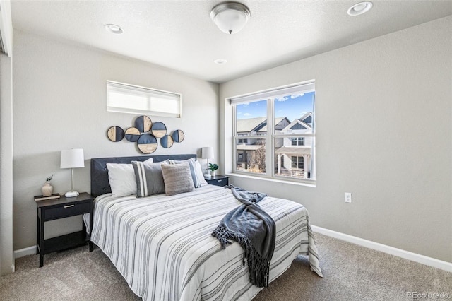 carpeted bedroom featuring baseboards