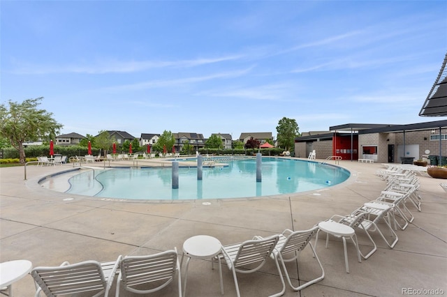 community pool with a patio area