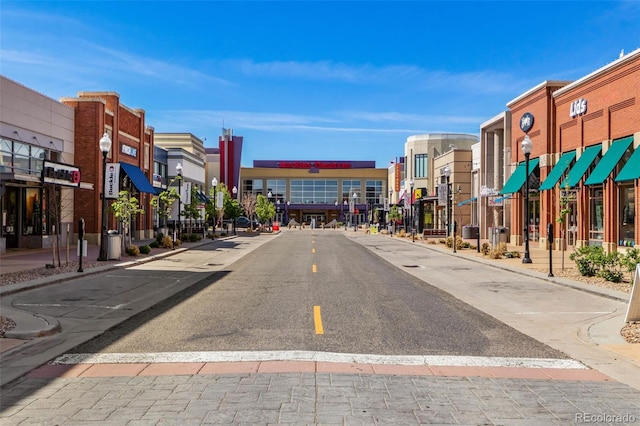 view of street with curbs, sidewalks, and street lights