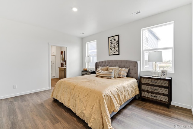 bedroom with visible vents, baseboards, and dark wood-style flooring