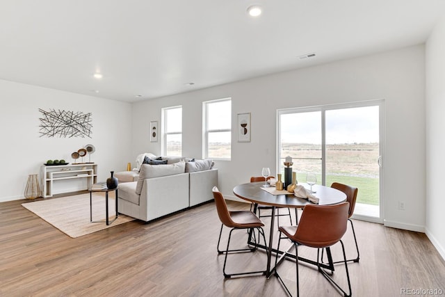 dining space with light wood-type flooring, visible vents, baseboards, and recessed lighting