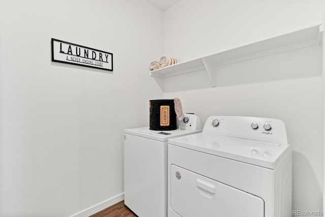 laundry room with dark wood finished floors, laundry area, baseboards, and washing machine and clothes dryer