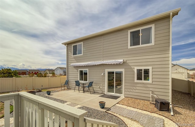 rear view of house featuring a patio and a fenced backyard