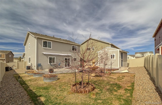 back of house with a patio area, a storage shed, a fenced backyard, an outdoor structure, and cooling unit