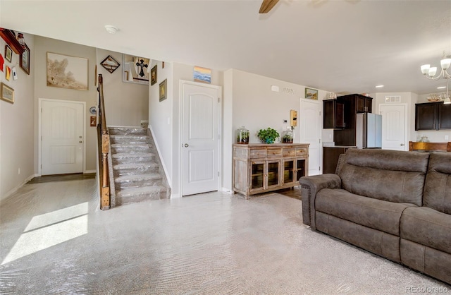living room featuring visible vents, baseboards, and an inviting chandelier