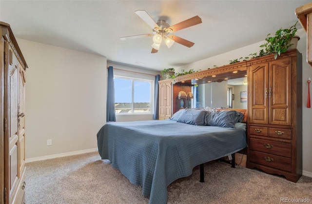 bedroom featuring baseboards, ceiling fan, and light colored carpet