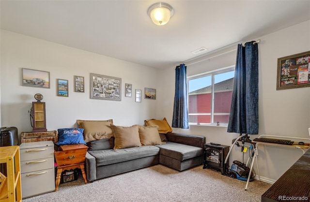 living area with carpet flooring and visible vents